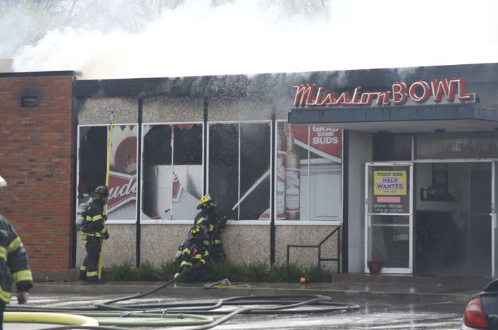 Smoke rolls out of the roof at the Mission Bowl.