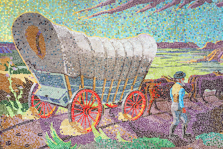 The mosaic mural of a wagon train party at The Village Shops.