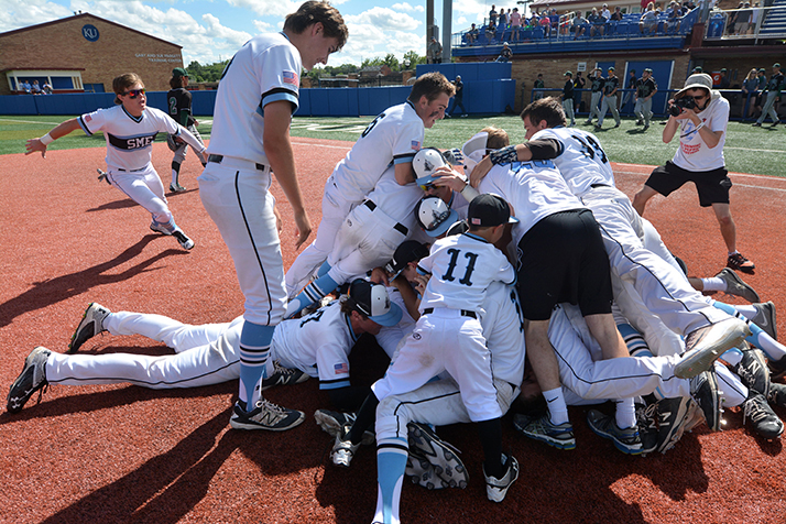 The Lancers form a mosh pit near first base after beating Lawrence Free State in extra innings. Photo by Joseph Cline