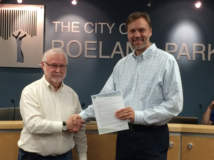 Ardie Davis (left) receives his proclamation from Roeland Park Mayor Joel Marquardt