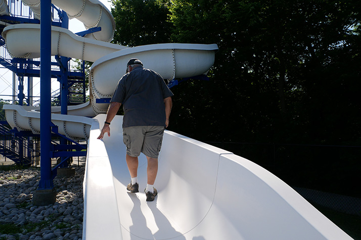 Pool slide inspector Dennis Sutherland is in town from Texas this week to examine Johnson County water slides. Photo courtesy city of Overland Park.