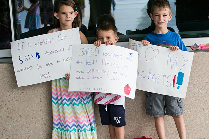 A group supporting teachers hosted a small rally outside the district offices before the negotiating session.