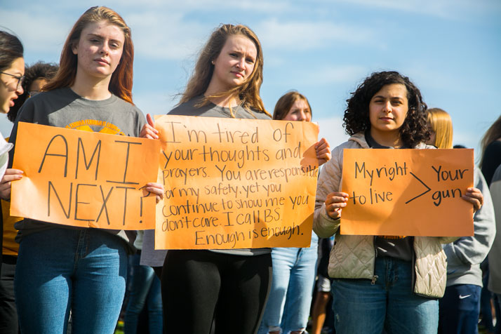 SM West students held signs calling for changes to stop school shootings during their National Walkout Day demonstration in April.