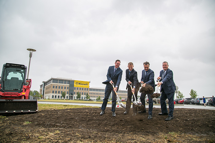 Lenexa Mayor Mike Boehm (right), former Kansas Gov. Jeff Colyer and Kiewit leaders Tom Shelby and Kevin Needham turned the dirt at a ceremony marking the start of construction on the engineering firm's City Center campus in 2018.