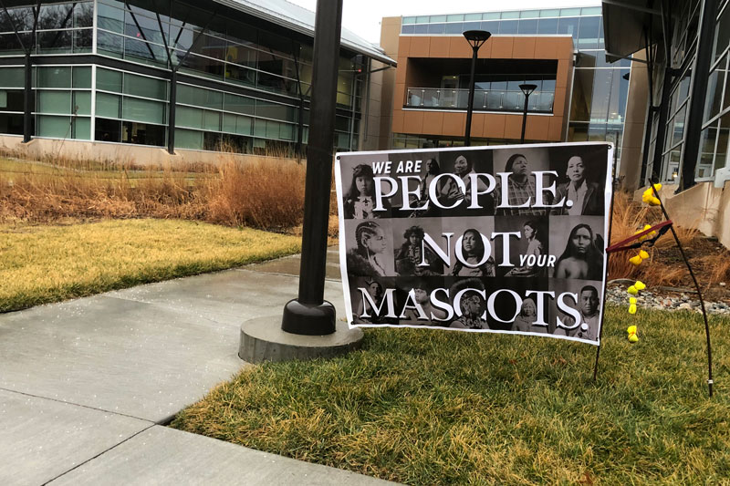 People are not mascots sign in front of Center for Academic Achievement