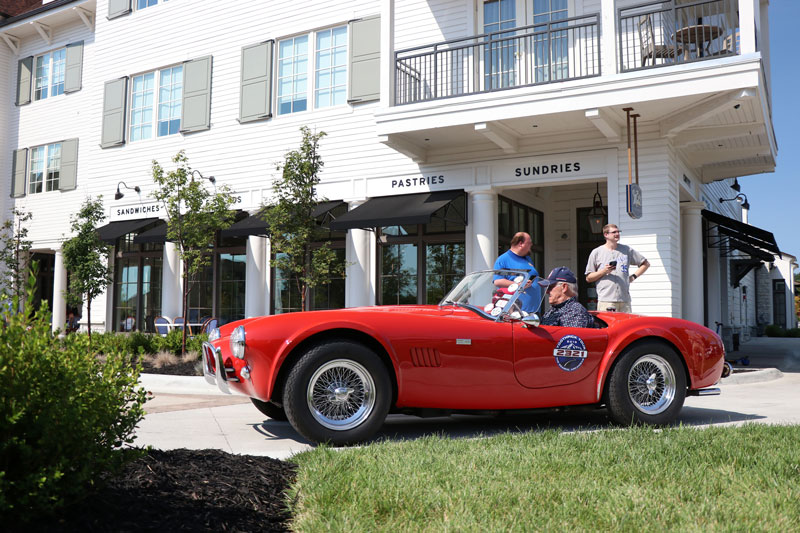A red car sits in front of The Inn at Meadowbrook
