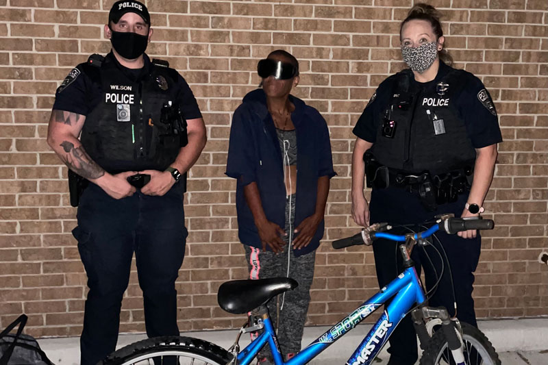 Roeland Park officers and woman with bike