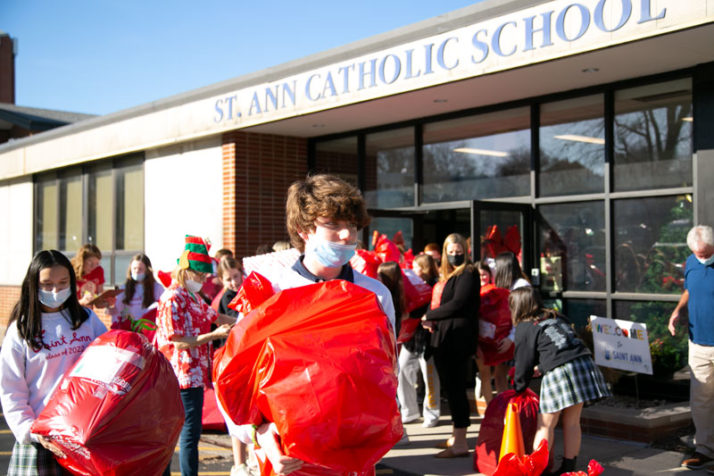 Student carries red bag 
