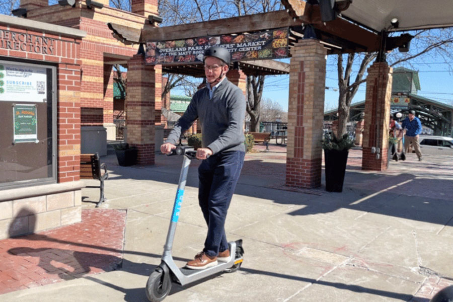 Mayor Curt Skoog rides an e-scooter in downtown Overland Park in 2022. Photo via city of Overland Park.