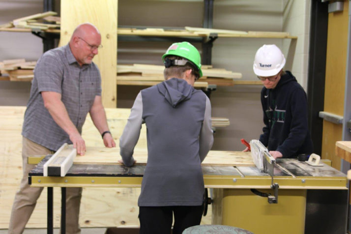 Students in USD 232 learn in a carpentry class in spring 2022.