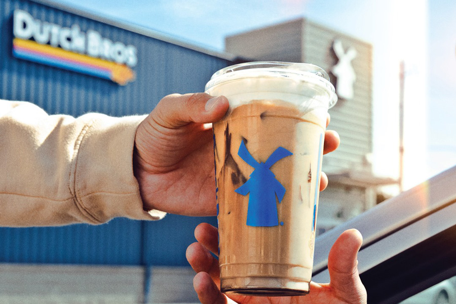 Dutch bros coffee cup handed to a customer