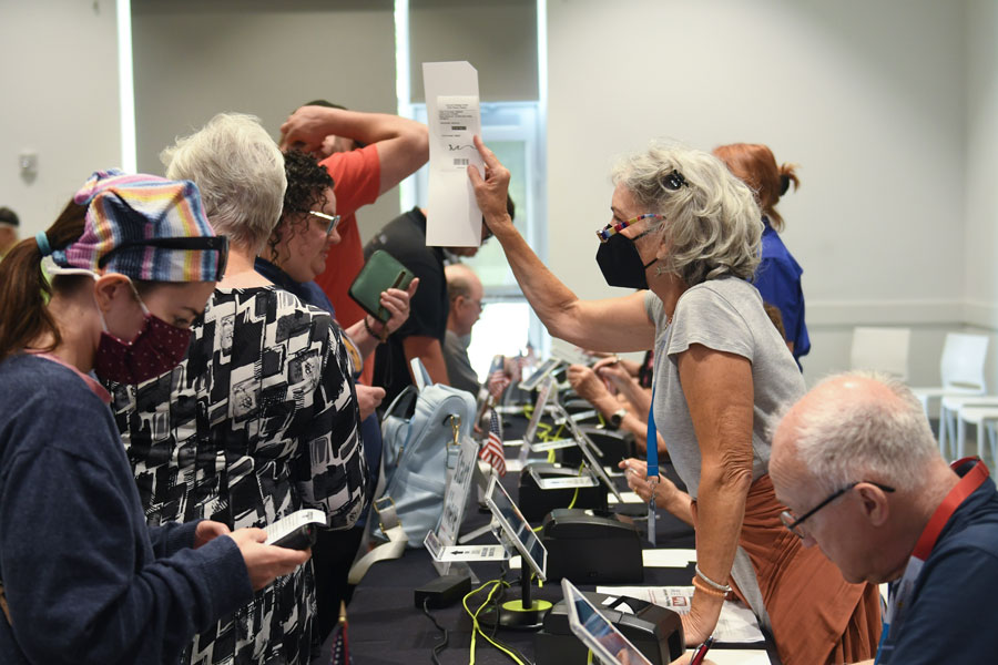 Johnson County election workers check voters in for Aug. 2 primary.