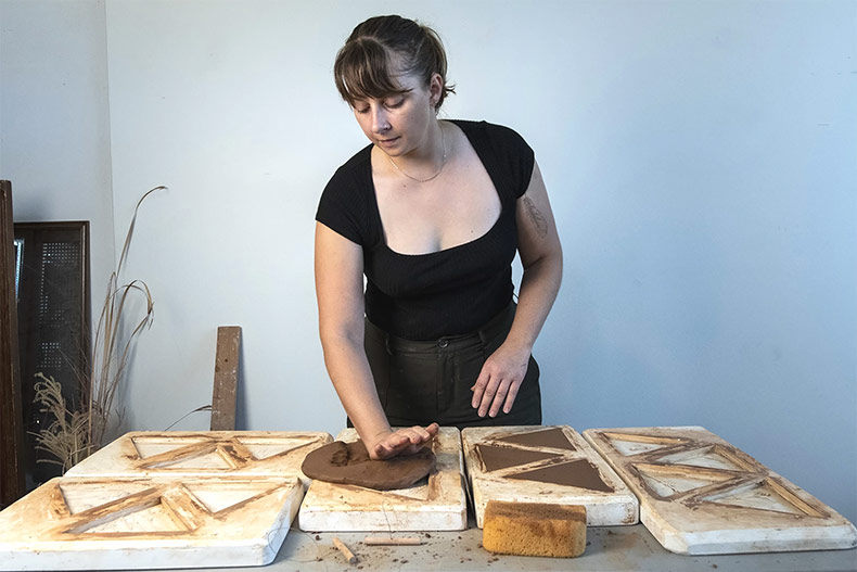 Artist Kirsten Taylor at work on ceramic tiles as part of an art installation at Shawnee Mission Park.