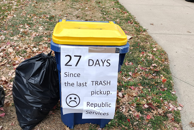 Lenexa resident with message on trash bin for Republic Services.