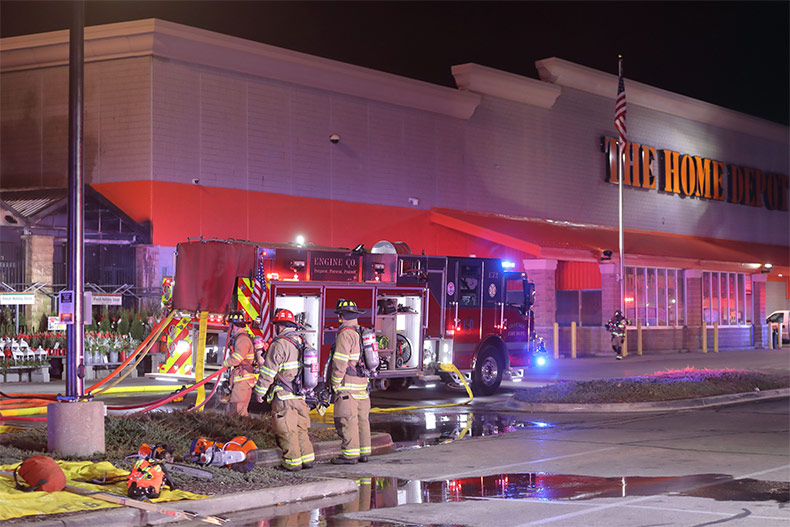 Firefighters ascend to the roof of the Shawnee Home Depot. A fire broke out in the store's garden center in December 2022 after hours, but its reopening in March 2023.