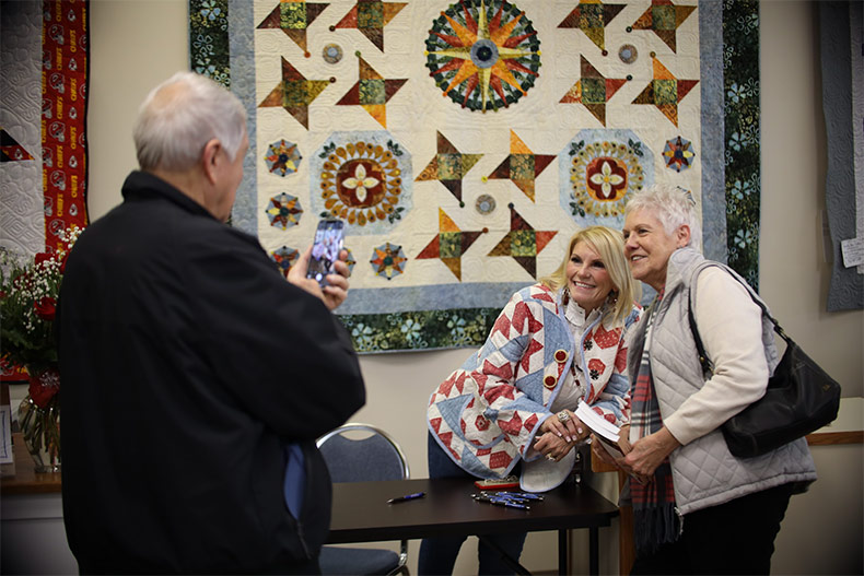 Tammy Reid poses for pictures in Prairie Point Quilt & Fabric Shop. 