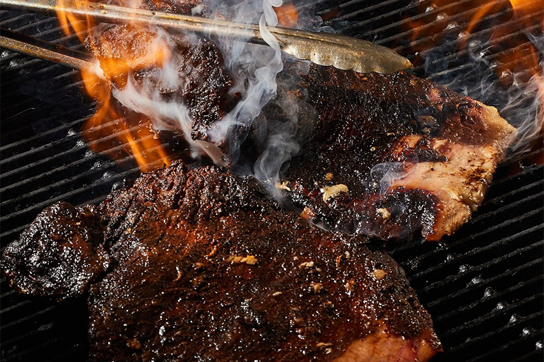Ribs cooking on the fire at Q39, one of the entries on Food Network's "50 States of Barbecue" list. 