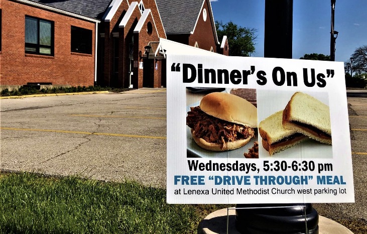 A sign in front of Lenexa United Methodist Church at 9138 Caenen Lake Rd tells each passerby that "dinner's on us" as part of the church's free Wednesday meal service. 