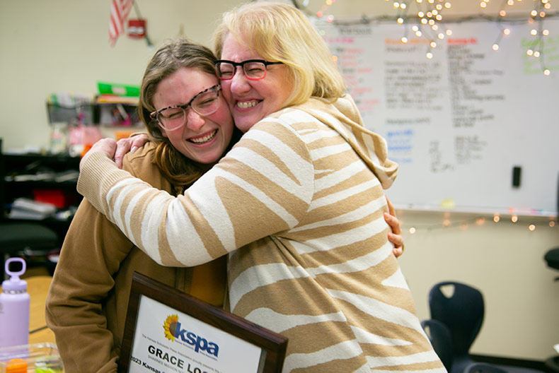 Susan Massy retires. Massy hugs student Grace Logan