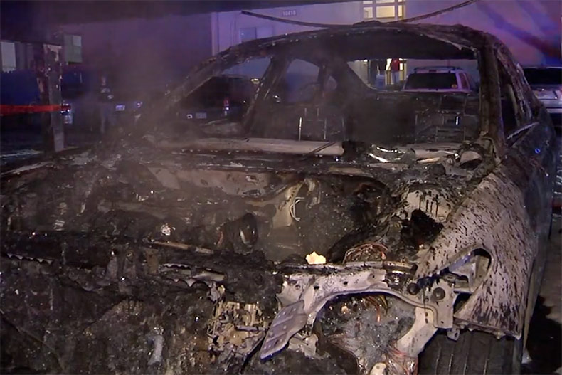 A car destroyed by fire at an Overland Park apartment carport.