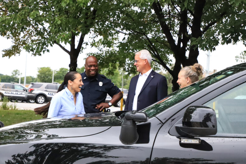 Rep. Davids (left) pictured with Officer John Lacy, Mayor Curt Skoog and a patrol officer pictured outside the Overland Park Justice Center and police department. On Monday, July 31, Davids visited the department for a conversation, tour and ride along.