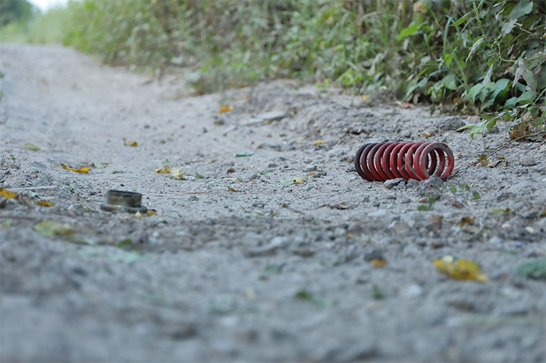 Debris from the damaged four-wheeler on a gravel trail at Riverfront Park.