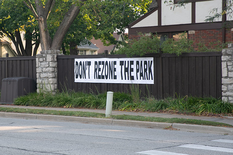 A September sign directly across the street from Joe D. Dennis Park, included in the Karbank project proposal, says "Don't rezone the park." File photo. 