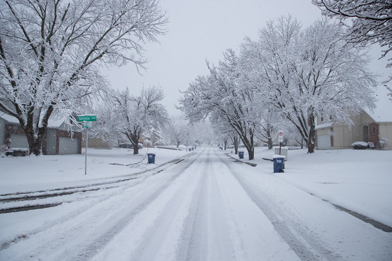 Snow falls Tuesday morning on the intersection of Ballentine and 115th Terrace in College Park Estates in Overland Park.