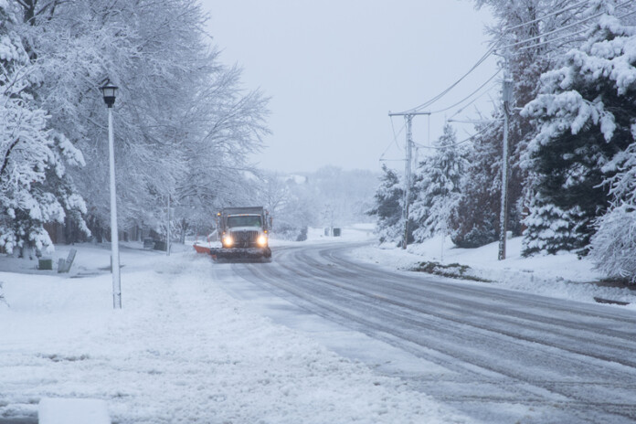 An Overland Park snow plow clears Nieman Road on the morning of Tuesday, Jan. 9.