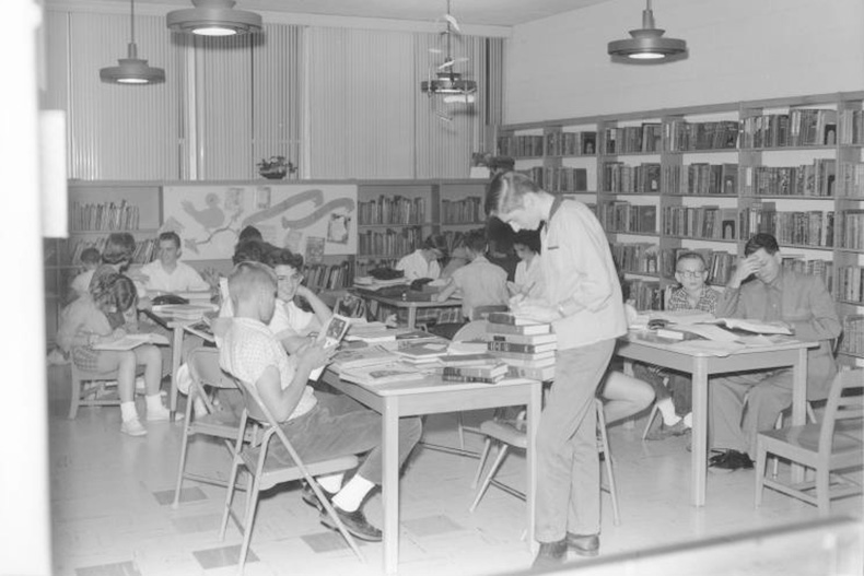 Tables inside Antioch Library are filled with books and patrons circa 1957. Photo via JoCo History. 