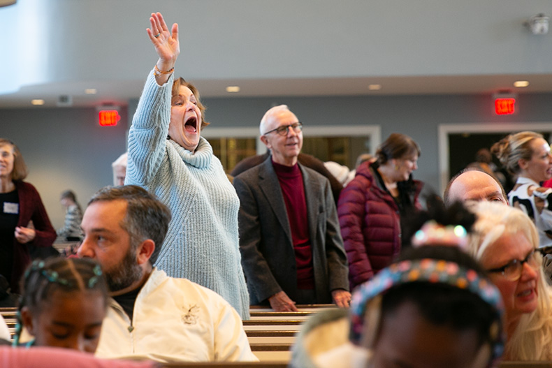 A crowd member interacts with others at the Prairie Village MLK celebration.