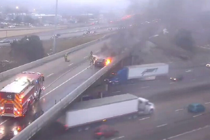 A KC Scout traffic camera caught the image of a vehicle on fire on the southbound I-35 ramp to southbound U.S. 69 Highway in Overland Park Wednesday evening. Image via KC Scout.