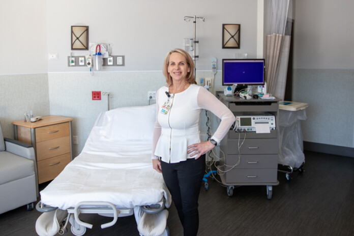 Director of Women’s Services Annette Hinton stands inside one of the renovated private bedrooms in the Labor and Delivery section of Menorah Medical Center in Overland Park, on Wednesday, Jan. 31.