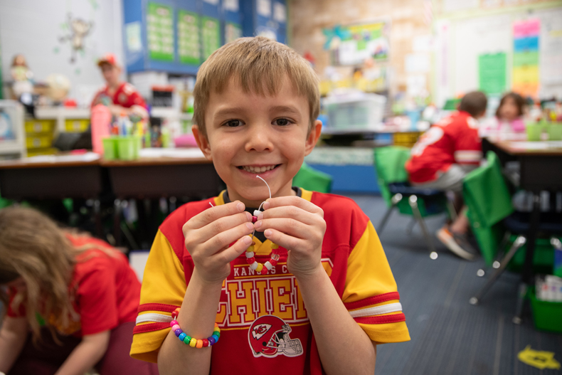  Bennett Ickaley poses for a picture with the bracelet he made to send to a student in California. Photo credit Kylie Graham. 