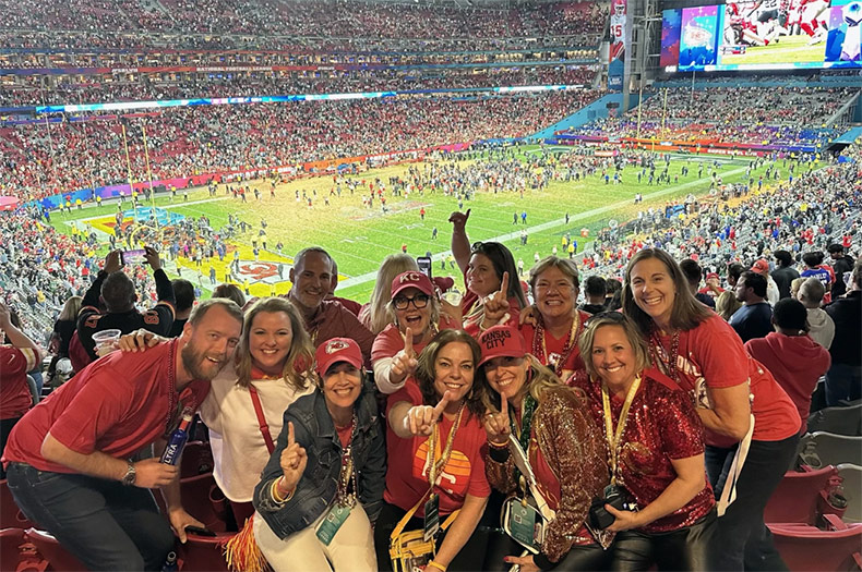 Kathleen Kunkler (wearing a KC hat and glasses), took a group of 10 friends to last year's Super Bowl in honor of her mother, Jo Kay, a Chiefs fan who died shortly before the championship game. They won, and Kunkler believes her mom watched the game with them. Photo courtesy Kathleen Kunkler.