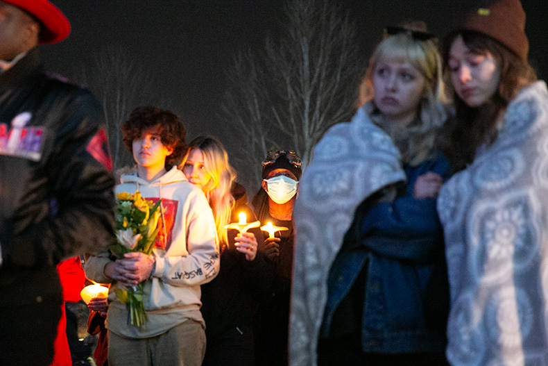 Vigil attendees hug each other