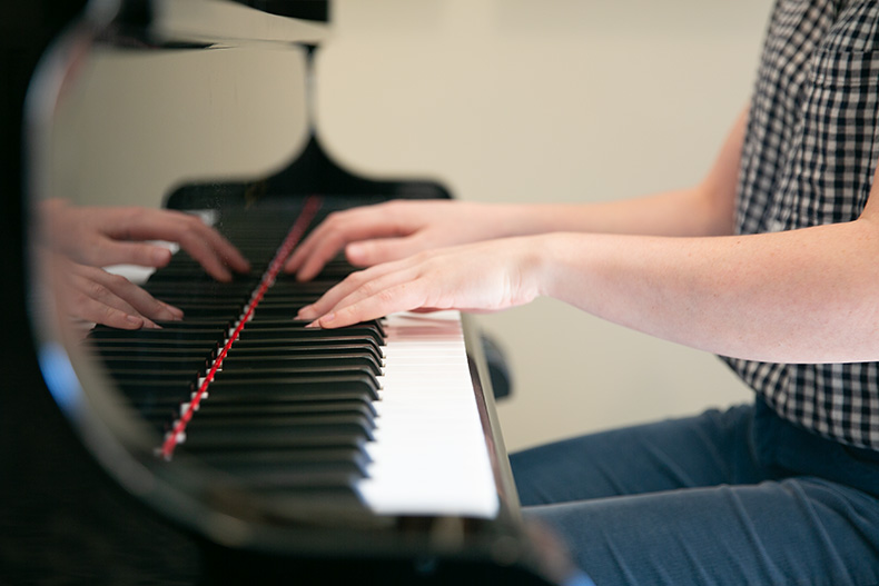 Claridge Court UMKC student plays the piano. 