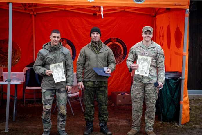 U.S. Army Sgt. Aaron Fouts (right) displays his third place certificate next to other international competitors in the Estonia Defence League's Long Range Distance Shooting Championship Series.