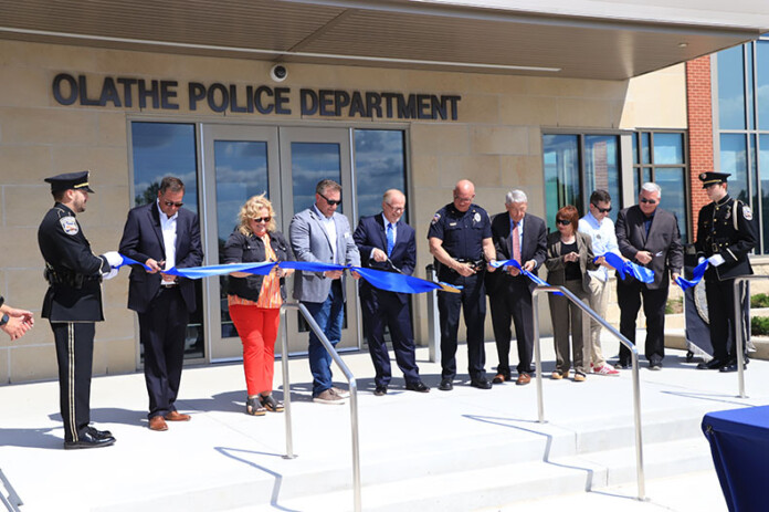 City leaders, including Mayor John Bacon and Chief Mike Butaud, mark the opening of the reimagined Olathe Police Department headquarters with a ribbon-cutting on Friday.
