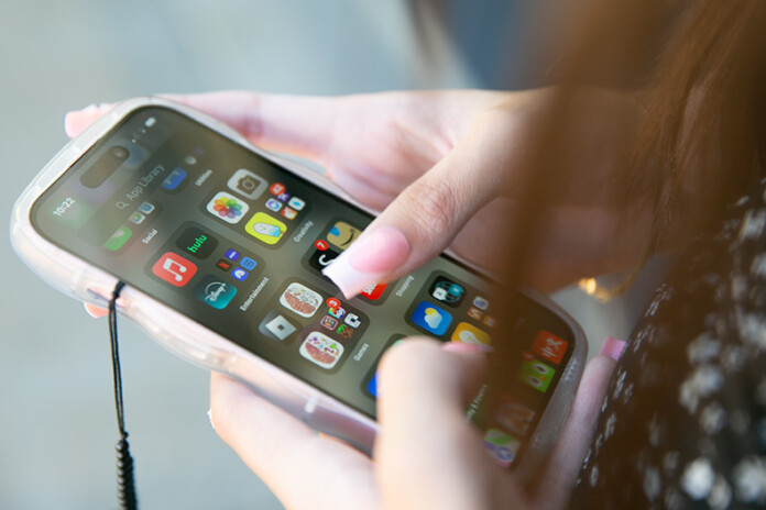 A middle schooler using an iPhone.