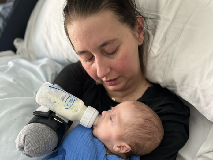 Brie Morgan Bauer holding her son, Beau, who was born premature. An infection during childbirth caused Morgan Bauer to require amputations of all four limbs.