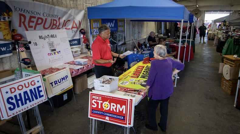 Republican Mike Storm, a candidate for Johnson County Board of Commissioners, visits with a constituent at the Johnson County Fair.