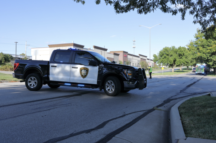 A Lenexa PD truck blocks the eastbound lanes of College Boulevard at Thompson Avenue, where a fatal crash occurred Saturday afternoon. Photo credit Mike Frizzell.