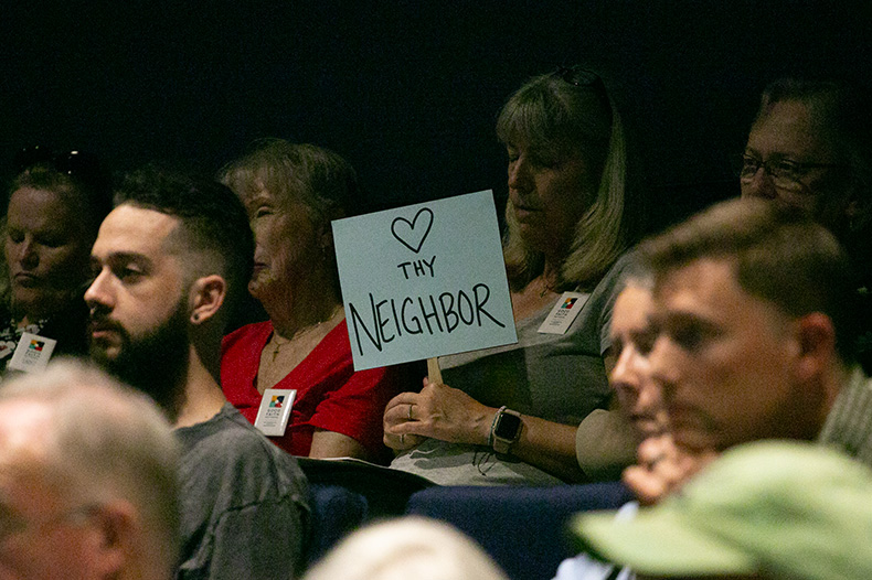 Love thy neighbor sign at the Lenexa City Council meeting.