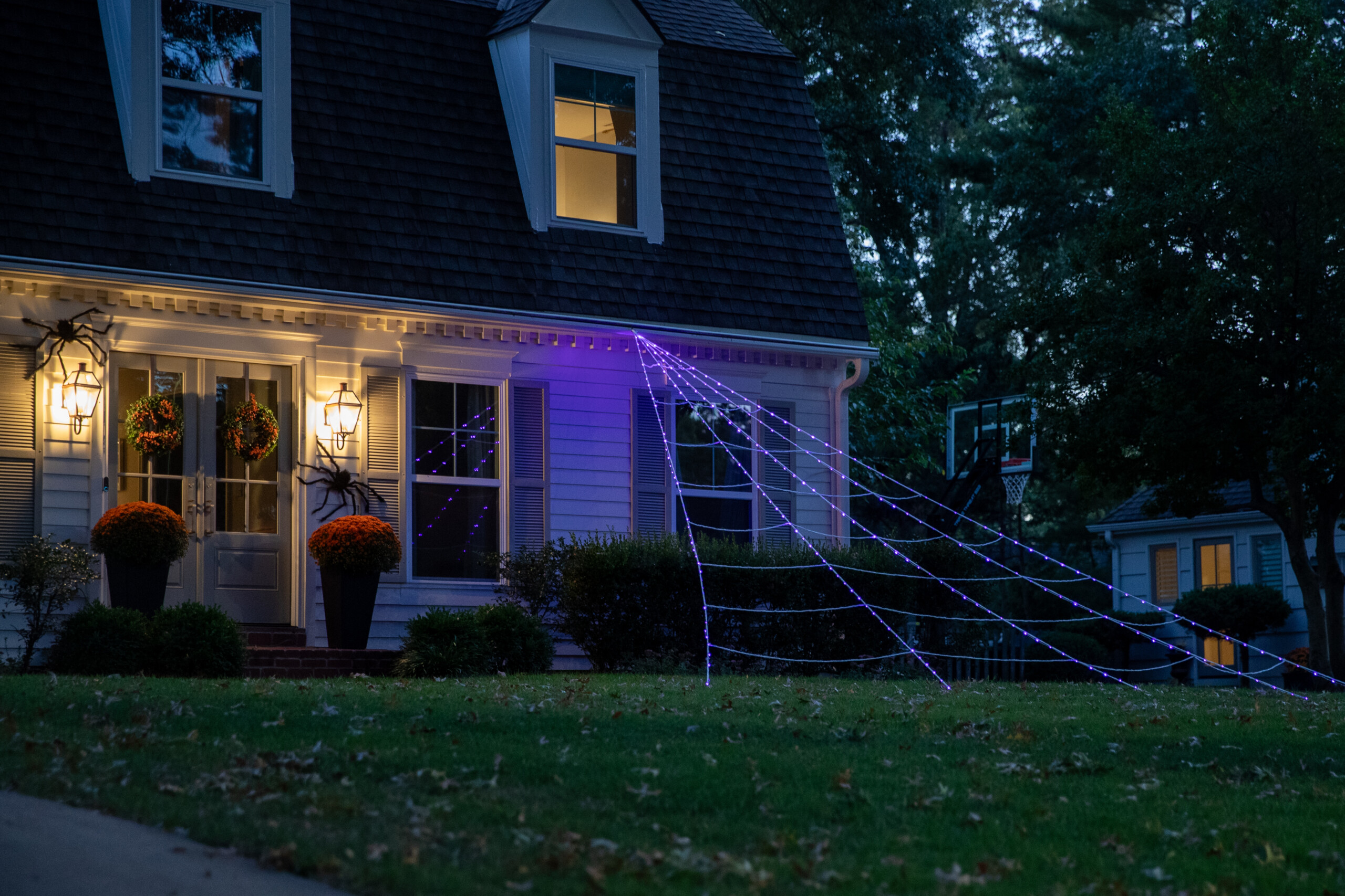 A purple light-up spider web stems from a home on Mission Road and West 92nd Place in Overland Park.