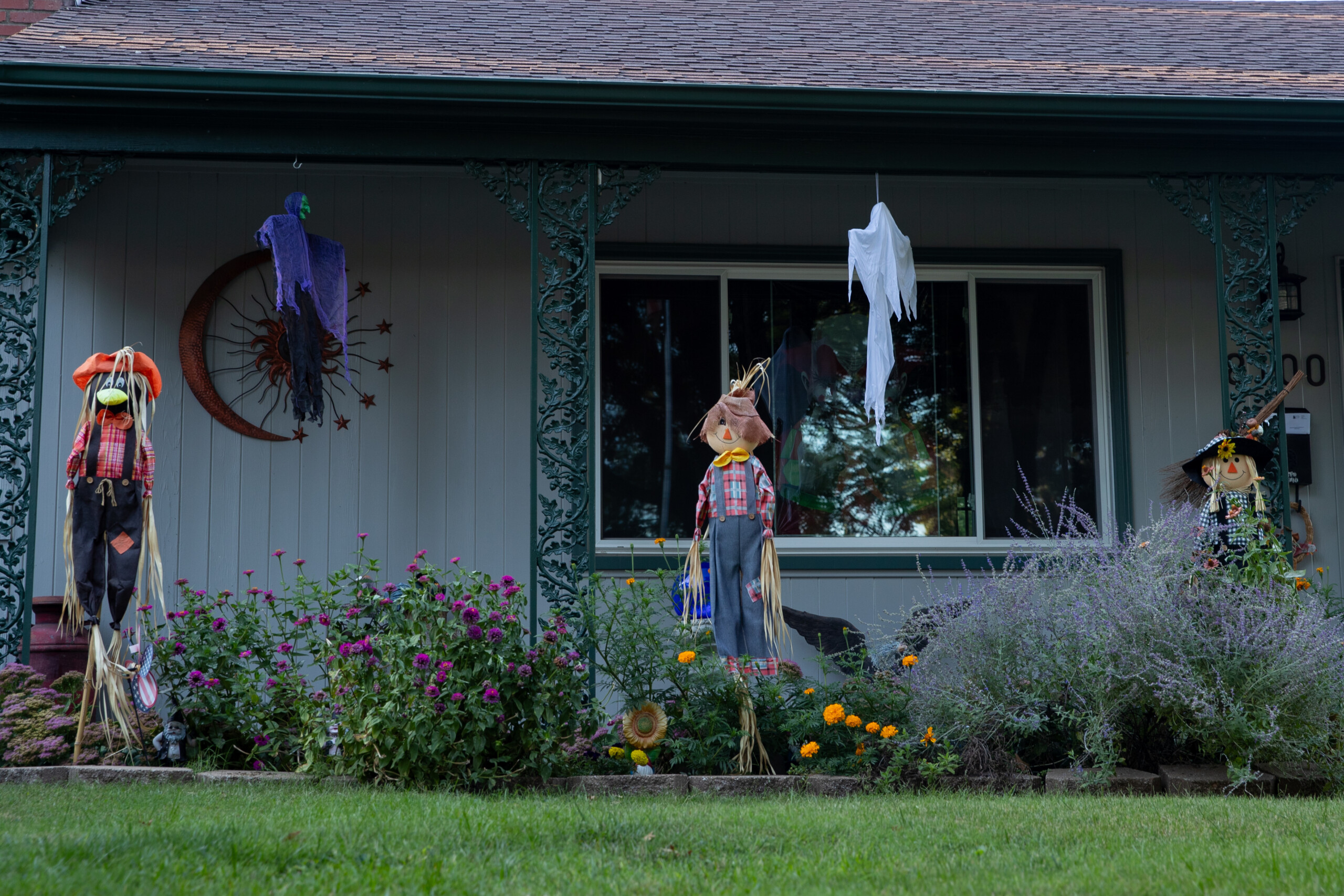 Scarecrows guard flowers outside of a home on West 89th Street and Craig Drive.