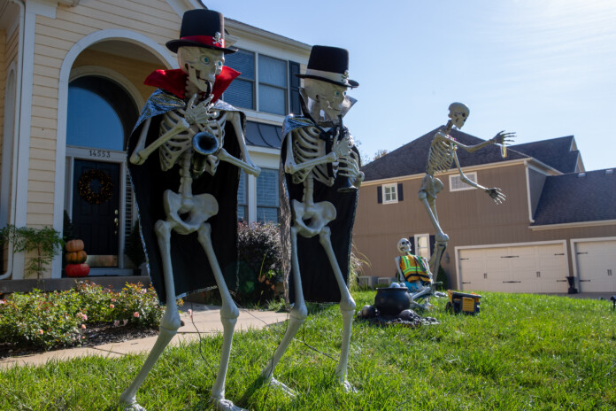 Giant skeletons playing instruments outside of a home on Windsor Drive and West 145th Street in Leawood.