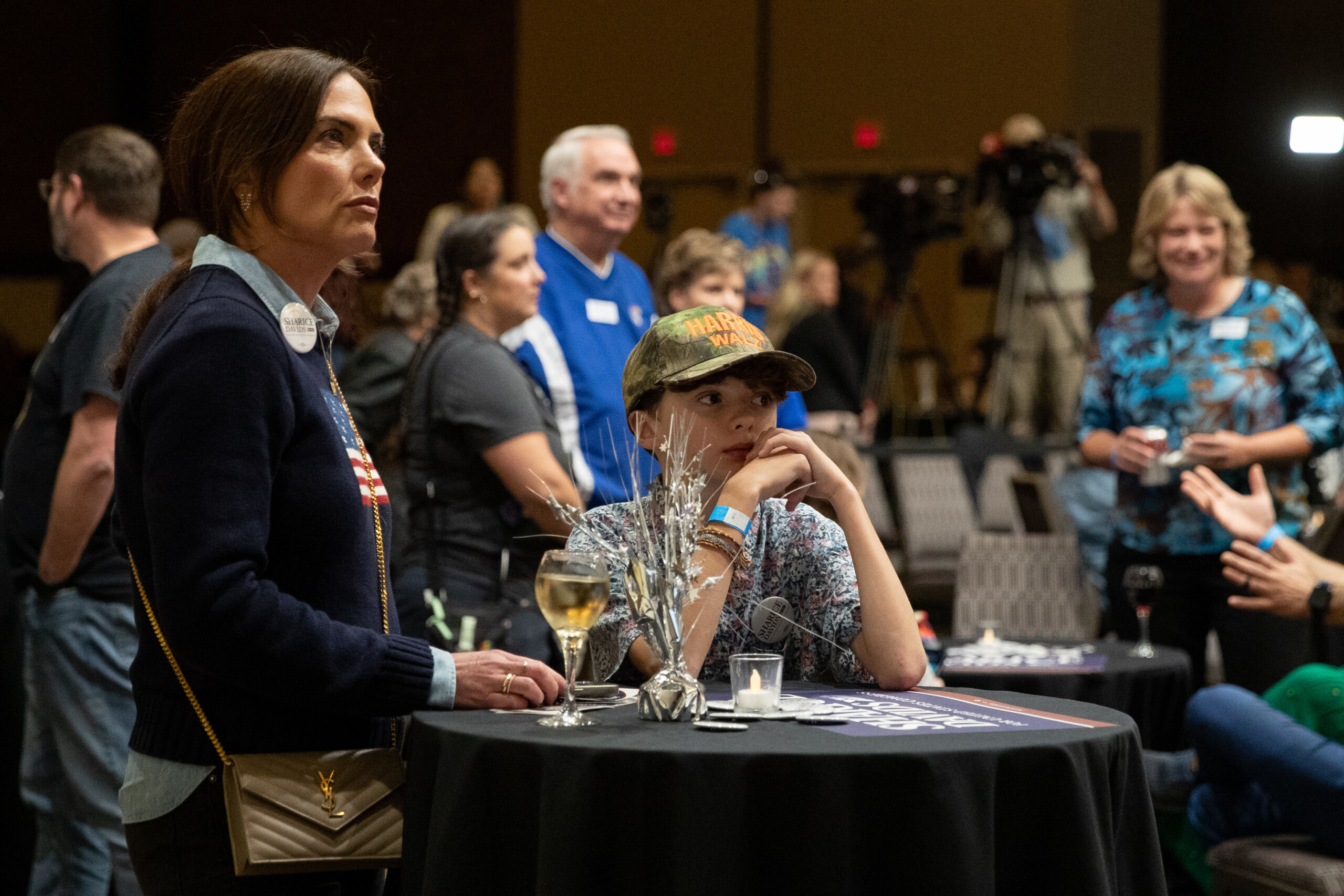 Christi Hiller (left) and Julian Vaglio watch as early results come in at the Johnson County Democratic Party's watch party.