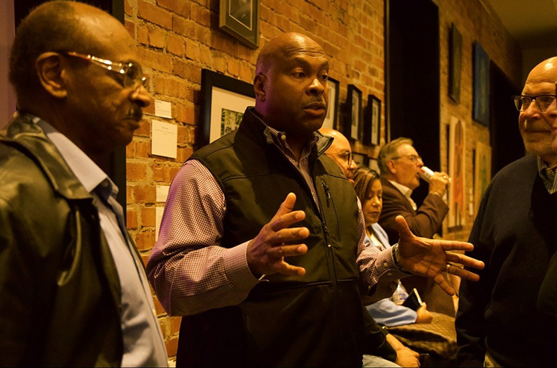 Byron Roberson (center) at a watch party at Shockey Consulting in downtown Overland Park.