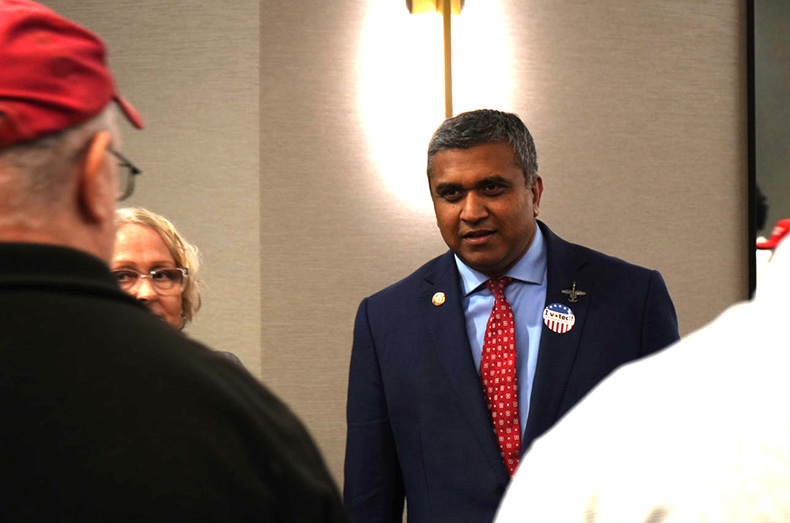 U.S. House candidate Prasanth Reddy talks with supporters at the Johnson County Republican Party's watch party.